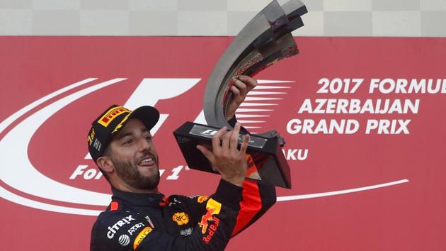 Red Bull driver Daniel Ricciardo of Australia holds the trophy on the podium after winning the Formula One Azerbaijan Grand Prix in Baku, Azerbaijan, on Sunday.(AP)