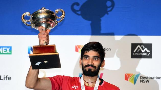 Kidambi Srikanth of India poses with the winner's trophy after defeating Chen Long of China in the Australian Open men's singles badminton final in Sydney.(AFP)