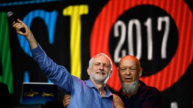 Britain's opposition Labour Party leader Jeremy Corbyn and Michael Eavis, the founder of the Glastonbury Festival of Music and Performing Arts, acknowledge the crowd after addressing revellers from the Pyramid Stage at Worthy Farm in Somerset during the Glastonbury Festival on Saturday. (REUTERS) Britain's opposition Labour Party leader Jeremy Corbyn and Michael Eavis, the founder of the Glastonbury Festival of Music and Performing Arts, acknowledge the crowd after addressing revellers from the Pyramid Stage at Worthy Farm in Somerset during the Glastonbury Festival on Saturday. (REUTERS)