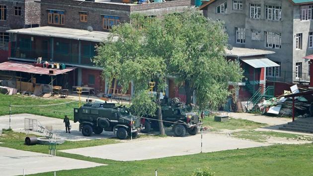 Bullet proof vehicles stationed in the premises of Delhi Public School (DPS) where two militants were holed up during an encounter with the security forces at Pantha Chowk in Srinagar on Sunday.(PTI Photo) Bullet proof vehicles stationed in the premises of Delhi Public School (DPS) where two militants were holed up during an encounter with the security forces at Pantha Chowk in Srinagar on Sunday.(PTI Photo)