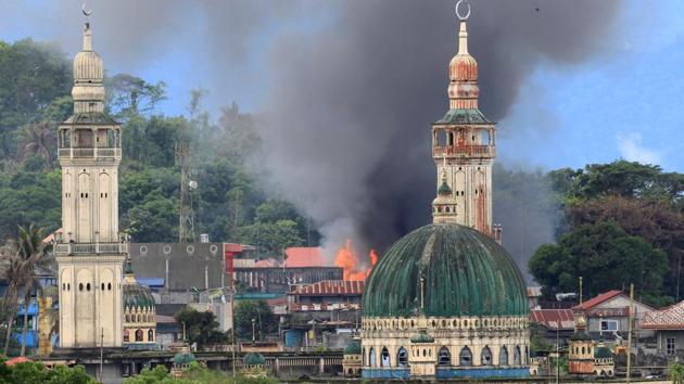 Smoke and fire are seen after an OV-10 Bronco aircraft released a bomb, during an airstrike, as government troops continue their assault against insurgents from the Maute group, who have taken over parts of Marawi city, Philippines on June 24, 2017. (Romeo Ranoco/REUTERS)