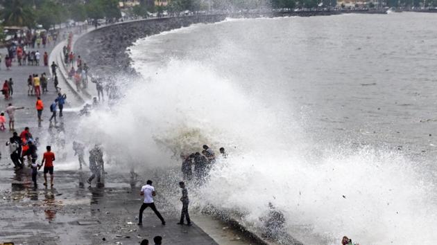 Locals feel the cool spray of seawater during high tide on Sunday. (Pratik Chorge/HT) 