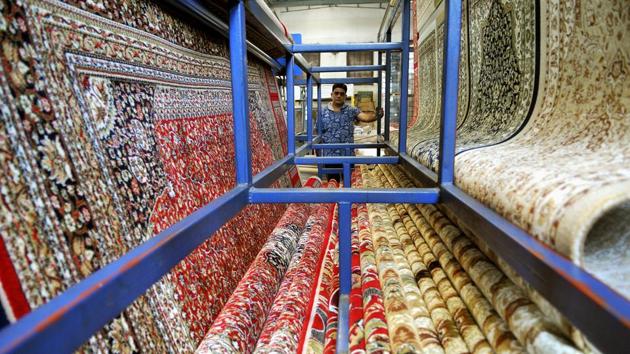 An employee arranging carpets at a factory in Bari Brahmana industrial area on Sunday. (Nitin Kanotra/HT Photo)