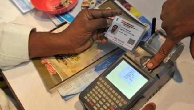 A man gives a thumb impression to withdraw money from his bank account with his Aadhaar or Unique Identification (UID) card during a Digi Dhan Mela, held to promote digital payment, in Hyderabad.(AFP FILE) A man gives a thumb impression to withdraw money from his bank account with his Aadhaar or Unique Identification (UID) card during a Digi Dhan Mela, held to promote digital payment, in Hyderabad.(AFP FILE)