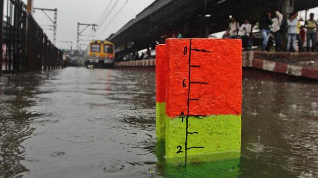 Thane railway station was waterlogged, inconveniencing commuters on Sunday. (Praful Gangurde/HT) 