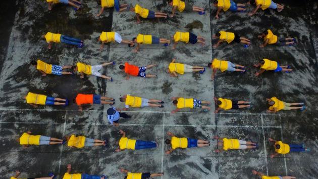 This photo taken on June 22, 2017 shows inmates exercising at a forced drug rehabilitation centre in Rongan, in China's southern Guangxi region. China marks the United Nations International Day against Drug Abuse and Illicit Trafficking on June 26. (AFP)