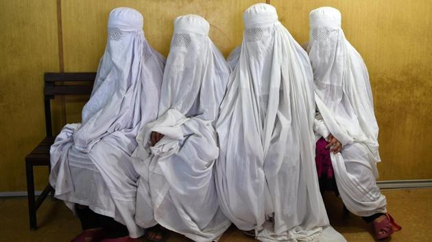 Afghan refugee women wait to scans their eyes at the UNHCR registration centre in the Pakistani city of Peshawar on June 19, 2017 ahead of the World Refugee Day. A record 370,000 Afghans left Pakistan last year, many of whom were second or even third generation migrants of people fleeing the Soviet invasion of Afghanistan during the 1980s, surging from 55,000 the year before. (Abdul Majeed/AFP)