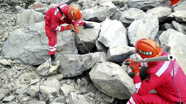 Paramilitary rescuers use sensors to check for signs of life in the rubble at the site of a landslide. According to official Xinhua News Agency rescue crews were ordered on Monday to evacuate the site of a deadly landslide in southwestern China over concerns of a second landslide. (AP) Paramilitary rescuers use sensors to check for signs of life in the rubble at the site of a landslide. According to official Xinhua News Agency rescue crews were ordered on Monday to evacuate the site of a deadly landslide in southwestern China over concerns of a second landslide. (AP)