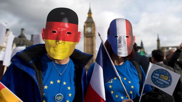 Protesters wearing German and French flags on their masks during a demonstration in London in February as part of a national day of action in support of migrants in the UK. (AFP) Protesters wearing German and French flags on their masks during a demonstration in London in February as part of a national day of action in support of migrants in the UK. (AFP)