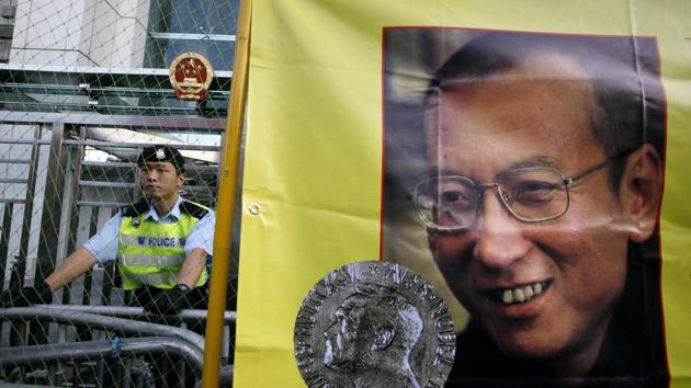 A police officer stands guard beside a picture of jailed Chinese dissident Liu Xiaobo outside the Chinese government liaison office in Hong Kong. (AP File) A police officer stands guard beside a picture of jailed Chinese dissident Liu Xiaobo outside the Chinese government liaison office in Hong Kong. (AP File)