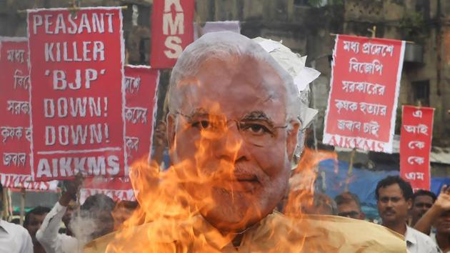 Farmers and social activists burn an effigy of Prime Minister Narendra Modi during a protest against the government and over the deaths of farmers in Madhya Pradesh. (AFP File) Farmers and social activists burn an effigy of Prime Minister Narendra Modi during a protest against the government and over the deaths of farmers in Madhya Pradesh. (AFP File)