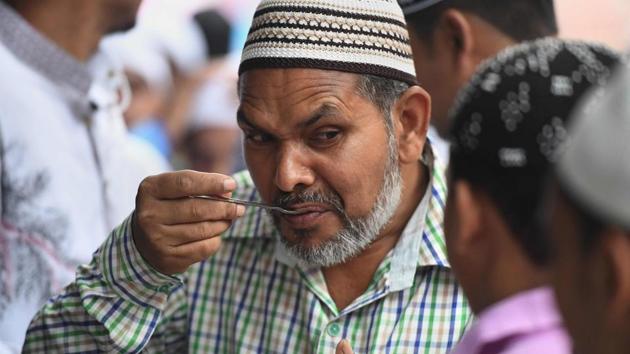 On the day of Eid-ul-Fitr, morning prayers are said and people pay family visits and celebrate with feasts. (Prakash Singh / AFP)