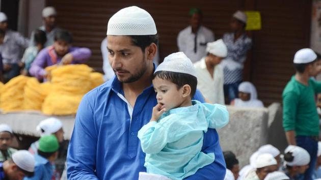 Worshipper with a toddler, celebrating Eid-ul-Fitr, in Ludhiana on Monday. People wear new clothes on Eid, visit their relatives and friends, and greet each other by saying Eid Mubarak. (Jagtinder Singh Grewal /HT Photo) Worshipper with a toddler, celebrating Eid-ul-Fitr, in Ludhiana on Monday. People wear new clothes on Eid, visit their relatives and friends, and greet each other by saying Eid Mubarak. (Jagtinder Singh Grewal /HT Photo)