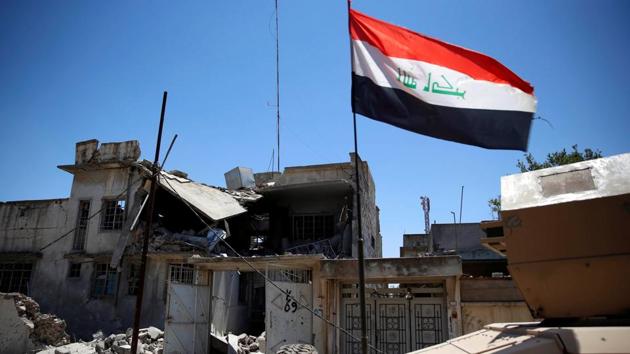 An Iraqi flag attached to an Iraqi military armoured fighting vehicle flutters past a destroyed house during clashes in the Shifa neighbourhood, Mosul, Iraq, June 15, 2017 (REUTERS) An Iraqi flag attached to an Iraqi military armoured fighting vehicle flutters past a destroyed house during clashes in the Shifa neighbourhood, Mosul, Iraq, June 15, 2017 (REUTERS)
