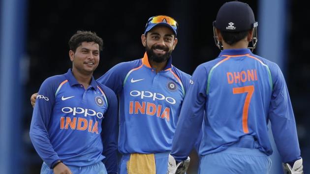 Kuldeep Yadav, left, celebrates with captain Virat Kohli and wicket keeper MSD Dhoni the dismissal of West Indies' captain Jason Holder. Catch highlights of India vs West Indies, 2nd ODI here(AP)