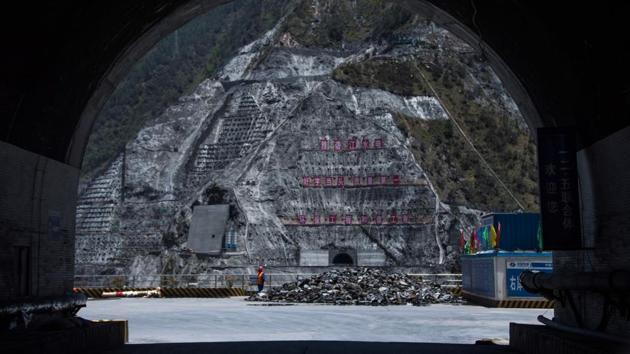 A worker stands next to the construction site of the Lianghekou dam. China had just two dams till 1949 but now has nearly half of the world’s total number of dams. (AFP) A worker stands next to the construction site of the Lianghekou dam. China had just two dams till 1949 but now has nearly half of the world’s total number of dams. (AFP)