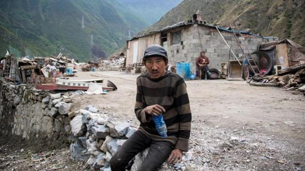 A man sits next to the debris of demolished houses and a makeshift hut near Lianghekou. Beijing is scaling up hydropower at breakneck pace as part of an ambitious undertaking to reduce the country’s dependence on coal and cut emissions that have made it the world’s top polluter. (AFP) A man sits next to the debris of demolished houses and a makeshift hut near Lianghekou. Beijing is scaling up hydropower at breakneck pace as part of an ambitious undertaking to reduce the country’s dependence on coal and cut emissions that have made it the world’s top polluter. (AFP)