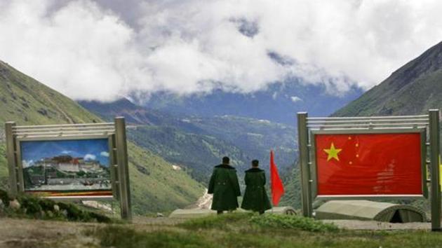 Chinese army officers oversee preparations as they stand between pictures of the Patola Palace, left, and the Chinese flag, on the Chinese side of the international border at Nathula Pass, in Sikkim. (AP File Photo) Chinese army officers oversee preparations as they stand between pictures of the Patola Palace, left, and the Chinese flag, on the Chinese side of the international border at Nathula Pass, in Sikkim. (AP File Photo)