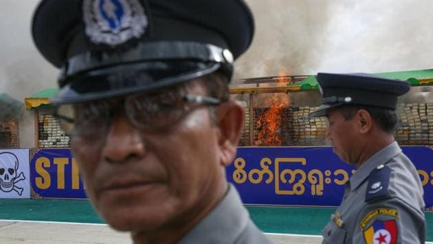 Myanmar police stand near the site where confiscated drugs were burnt to commemorate World Anti-Drugs Day on the outskirts of Yangon. According to a senior police official this was the biggest burning of seized drugs in the history of Myanmar. (AFP) Myanmar police stand near the site where confiscated drugs were burnt to commemorate World Anti-Drugs Day on the outskirts of Yangon. According to a senior police official this was the biggest burning of seized drugs in the history of Myanmar. (AFP)