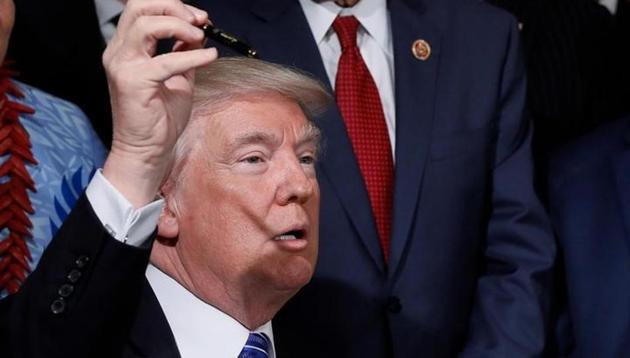 US President Donald Trump holds up a pen after signing the “VA Accountability Act” in the East Room of the White House in Washington. (Reuters) US President Donald Trump holds up a pen after signing the “VA Accountability Act” in the East Room of the White House in Washington. (Reuters)