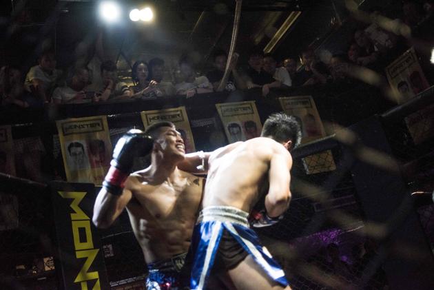Two men fighting in the dimly lit Monster Club in Chengdu. (AFP) Two men fighting in the dimly lit Monster Club in Chengdu. (AFP)