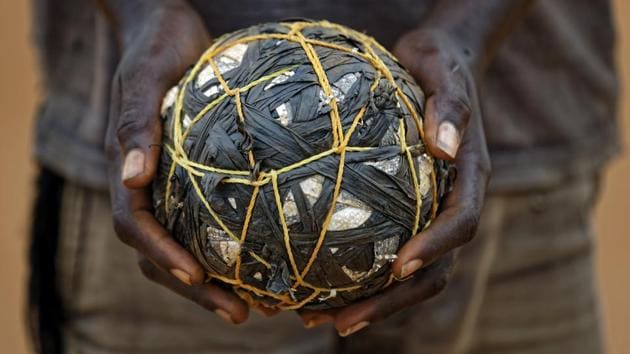A South Sudanese refugee boy holds a makeshift ball as he plays with his friends.  (Ben Curtis / AP) 