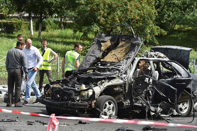 Ukrainian police officers and secret services experts examine the car after a blast in Kiev. (AFP) Ukrainian police officers and secret services experts examine the car after a blast in Kiev. (AFP)