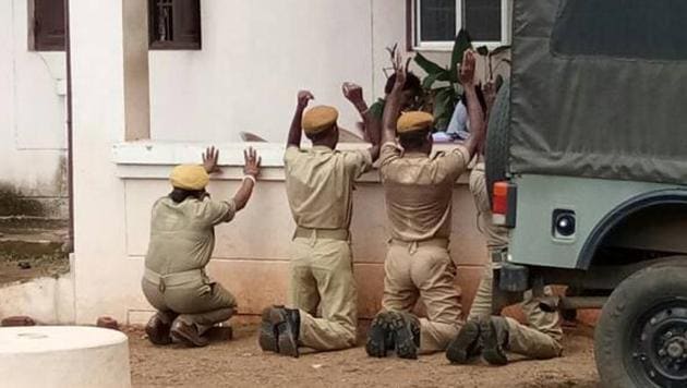 Four home guards, including a woman, were seen kneeling down, and the photo went viral on social media. (HT Photo) Four home guards, including a woman, were seen kneeling down, and the photo went viral on social media. (HT Photo)