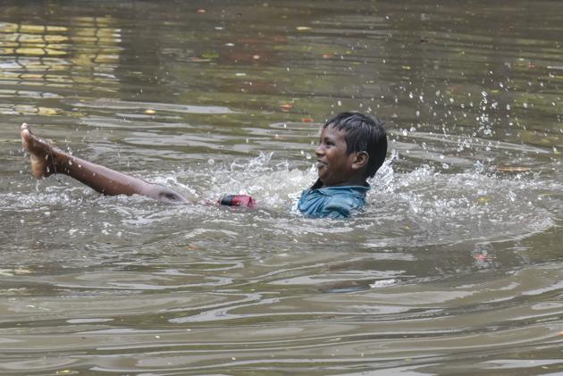 A child plays on a flooded street in Sion on Tuesday. (Kunal Patil/HT Photo) A child plays on a flooded street in Sion on Tuesday. (Kunal Patil/HT Photo)