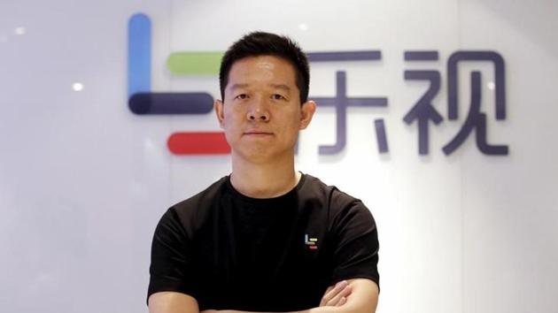 Jia Yueting, co-founder and head of Le Holdings Co Ltd, also known as LeEco and formerly as LeTV, poses for a photo in front of a logo of his company after a Reuters interview at LeEco headquarters in Beijing.(Reuters file photo)