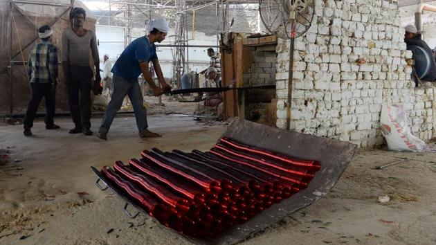 These factories date back to almost as far as the Mughal-era mausoleum. A Supreme Court ruling in 1999, giving Firozabad two years to retrofit their factories with gas instead of coal, has gradually eroded their razor-thin margins, pushing many to the wall. (Sajjad Hussain /AFP) These factories date back to almost as far as the Mughal-era mausoleum. A Supreme Court ruling in 1999, giving Firozabad two years to retrofit their factories with gas instead of coal, has gradually eroded their razor-thin margins, pushing many to the wall. (Sajjad Hussain /AFP)