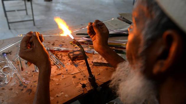 In the blazing-hot workshops dotting the district of Firozabad, the Taj Mahal is a sore subject for craftsmen toiling over thousand-degree furnaces to fashion the glittering bangles that sell for pennies across India.The ancient glass quarter in Firozabad never recovered after authorities blamed smoke drifting from its furnaces for the yellowing of Taj’s radiant white marble, threatening the beauty of India’s number-one tourist attraction. The artisans were banned from burning coal and forced to use costly natural gas to fuel their furnaces instead -- with no discernable improvements to the Taj, two decades on. (Sajjad Hussain /AFP) In the blazing-hot workshops dotting the district of Firozabad, the Taj Mahal is a sore subject for craftsmen toiling over thousand-degree furnaces to fashion the glittering bangles that sell for pennies across India.The ancient glass quarter in Firozabad never recovered after authorities blamed smoke drifting from its furnaces for the yellowing of Taj’s radiant white marble, threatening the beauty of India’s number-one tourist attraction. The artisans were banned from burning coal and forced to use costly natural gas to fuel their furnaces instead -- with no discernable improvements to the Taj, two decades on. (Sajjad Hussain /AFP)