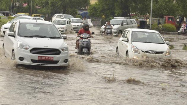 An intersection in Sector 12 turned into a rivulet when the skies opened up last week.(HT Photo)