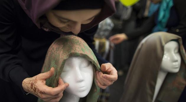 A woman ties an Islamic head scarf onto the head of a mannequin in Moscow.(AP File Photo / Representational)