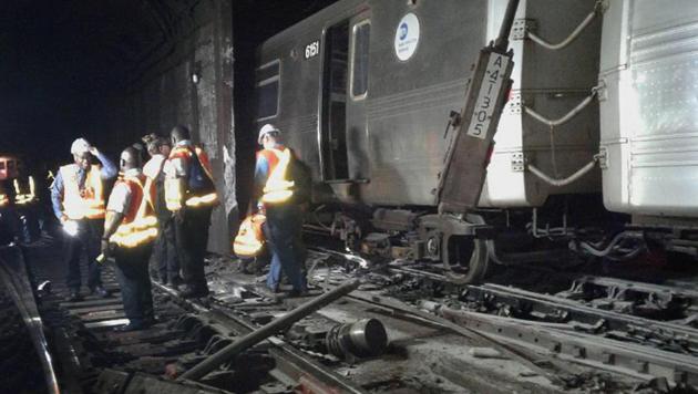 In this photo provided by the Transport Workers Union, Local 100, workers from the New York Metropolitan Transportation Authority examine damaged train tracks, at the scene of a subway derailment, Tuesday, June 27, 2017, in New York. (AP) In this photo provided by the Transport Workers Union, Local 100, workers from the New York Metropolitan Transportation Authority examine damaged train tracks, at the scene of a subway derailment, Tuesday, June 27, 2017, in New York. (AP)