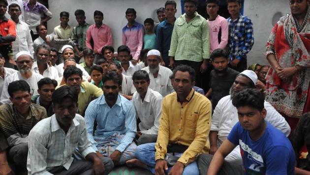 The 15 men, who spent a week in jail, with their family members and villagers in Burhanpur. They were forced to clean toilets and drains. Refusal to do so invited more beatings. (Mujeeb Faruqui/HT) The 15 men, who spent a week in jail, with their family members and villagers in Burhanpur. They were forced to clean toilets and drains. Refusal to do so invited more beatings. (Mujeeb Faruqui/HT)