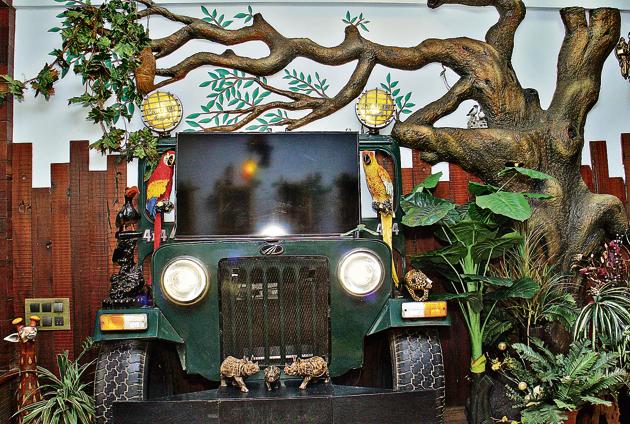 For a jungle­ themed home at the Pandits’, a part of a jeep has been stuck under a tree on which they place their television.(Pramod Thakur)