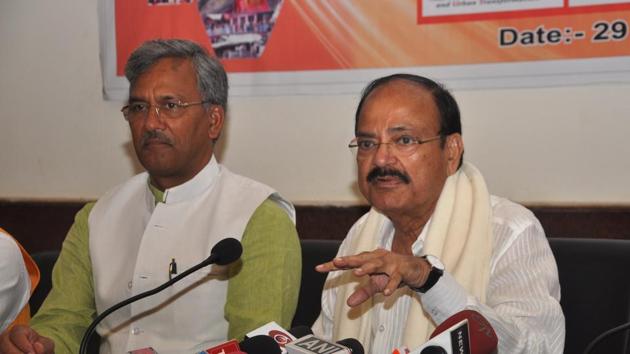 Union minister Venkaiah Naidu addresses the media in Dehradun on Thursday. Chief minister TS Rawat is seated next to him.(Vinay Santosh Kumar /HT)