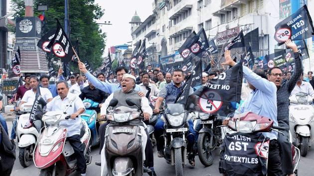 Textile traders shout slogans as they take part in a bike rally in protest against GST in Hyderabad on Thursday.(PTI Photo)