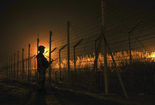 BSF soldier standing guard during a night patrol near the fence at the India-Pakistan International Border at the outpost of Akhnoor sector, about 40 km from Jammu. (HT File Photo) BSF soldier standing guard during a night patrol near the fence at the India-Pakistan International Border at the outpost of Akhnoor sector, about 40 km from Jammu. (HT File Photo)