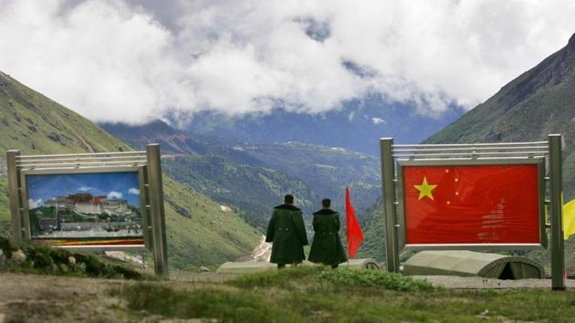 Chinese army officers oversee preparations as they stand on the Chinese side of the frontier at Nathu La along India’s northeastern border in Sikkim.(AP file photo)