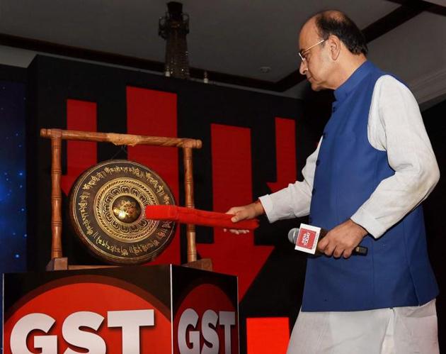 Finance minister Arun Jaitley hits the GST Bell at India Today's Conclave on GST in New Delhi on Friday.(PTI Photo)