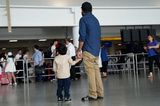 People wait at an airport in New York ahead of the travel ban. (Reuters) People wait at an airport in New York ahead of the travel ban. (Reuters)