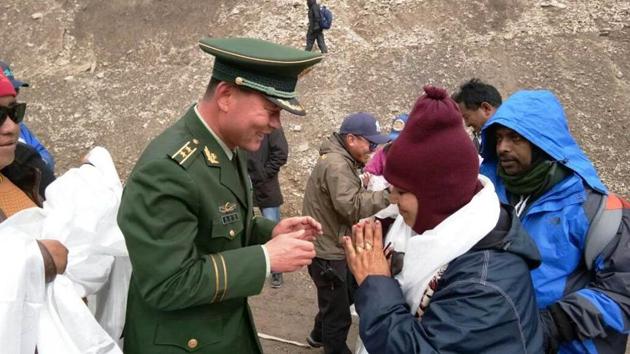 A Chinese army officials greets first batch of Kailash Mansarovar pilgrims from India at Taklakot, also known as Burang City in China.(FILE PHOTO)