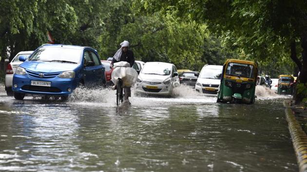 Vehicles pass through a waterlogged road in Gurgaon. Monsoon to hit Delhi by July 4. (Sanjeev Verma/HT PHOTO) Vehicles pass through a waterlogged road in Gurgaon. Monsoon to hit Delhi by July 4. (Sanjeev Verma/HT PHOTO)