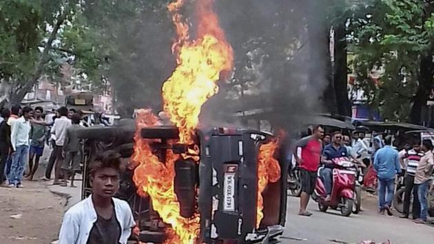 Members of a community torch a vehicle during a protest against lynching of a man by another community, in Ramgarh district of Jharkhand. (PTI Photo) Members of a community torch a vehicle during a protest against lynching of a man by another community, in Ramgarh district of Jharkhand. (PTI Photo)