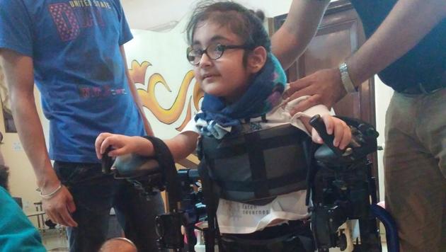 Maggu’s nephew Praneit, nine, trying out the exoskeleton in Delhi.(Courtesy Trexo Robotics)