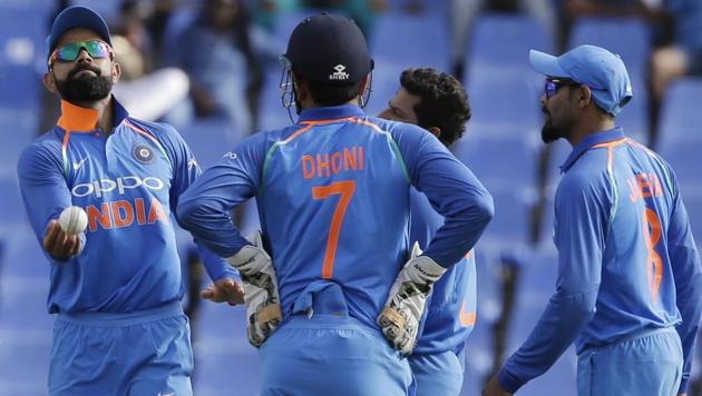 India's captain Virat Kohli, left, and teammates celebrate the dismissal of West Indies' Miguel Cummins during their third ODI cricket match at the Sir Vivian Richards Stadium in North Sound, Antigua.(AP)