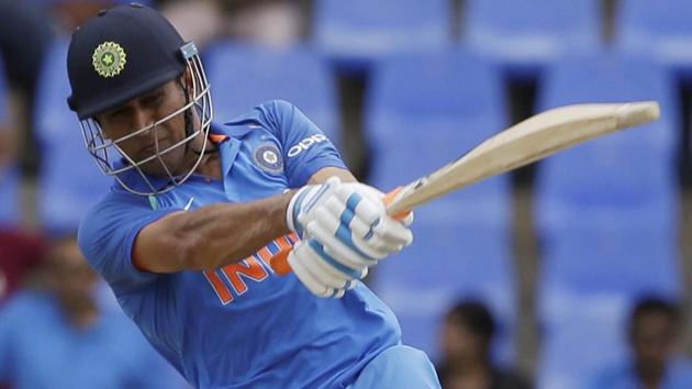 India's MS Dhoni plays a shot against West Indies during their third ODI cricket match at the Sir Vivian Richards Stadium.(AP)