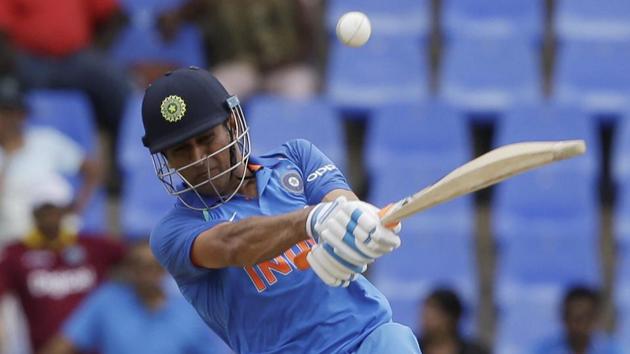 India's MS Dhoni plays a shot against West Indies captain Jason Holder during their third ODI at the Sir Vivian Richards Stadium in North Sound, Antigua and Barbuda, on Friday.(AP)